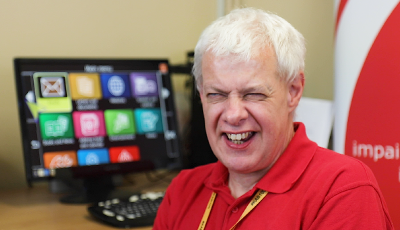 Assistive technology trainer who is visually impaired smiling